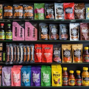 “Variety of colourful stand-up pouches displayed on a retail shelf, including snacks, jerky, sauces, and spices, showcasing how bold flexible packaging enhances shelf impact.